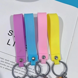 Macro detail of four colorful silicone keychain straps in pastel purple blue pink and yellow