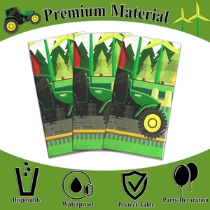 Detail of waterproof tractor farm theme tablecloth featuring green harvester patterns