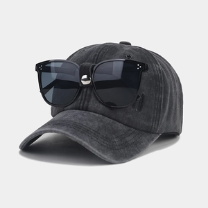 Detail of dark grey washed cotton baseball cap with integrated pilot style black sunglasses