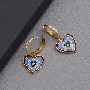Macro detail of heart earrings with multi-colored enamel layers and zircon inlay
