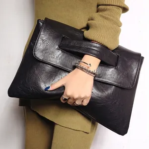 Classic black PU leather large clutch bag with hand strap for versatile crossbody use