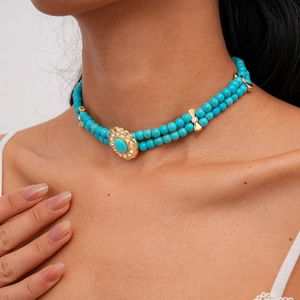 Detail view of turquoise double-layered choker with vintage crystal gemstone and gold accents