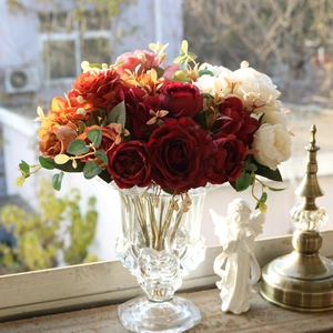 Close-up of vintage silk hydrangea and rose bouquet in a clear glass vase for decor