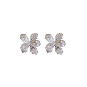 Sparkling silver flower stud earrings with full rhinestone pavé on a white background