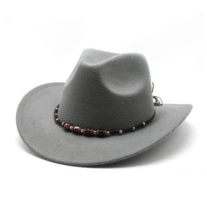 Detail of grey felt cowboy hat featuring handcrafted brown braided band with red beads