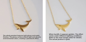 Close-up of whale necklace showing unique polished and matte gold-plated finishes