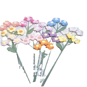 Handmade crochet puff flower bouquet with colorful knitted blossoms on white background