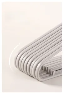 Detail of grey seamless hangers featuring ergonomic anti-slip shoulder curves for clothes