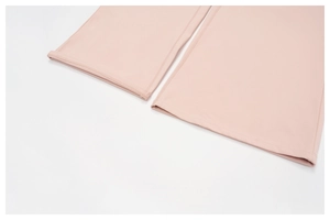 Detailed close-up of pink sports pants hem showing high-quality double-stitch sewing