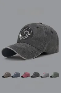 Detailed close-up of washed cotton baseball caps with vintage military embroidery