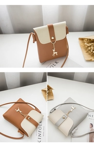 Detailed view of mini phone bag featuring a metal deer pendant and elegant flap design
