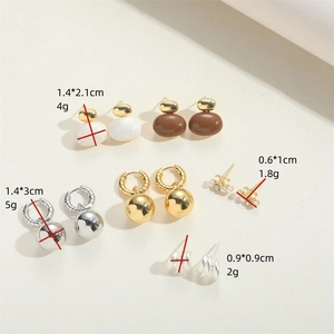 French vintage 14K gold plated earring set with pearls and crystals on beige surface