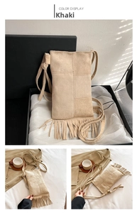 Detail of khaki suede crossbody bag showing long tassels and bohemian fringe elements