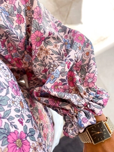 Detail of floral print chiffon blouse showing elasticated ruffled cuffs and soft fabric texture