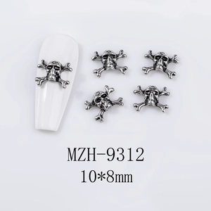 Macro detail of 10x8mm retro silver skull and crossbones alloy nail art charms