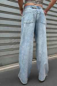 Detail view of baggy washed denim jeans showing back pocket design and loose fit