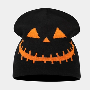 Detailed view of black Halloween beanie featuring orange jack-o-lantern knitted pattern