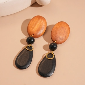 Retro geometric drop earrings with brown oval wood and black beads on beige background