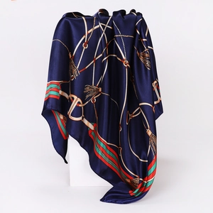Detail of navy blue square silk scarf with vintage equestrian pattern and satin luster