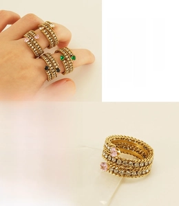 Close-up of multi-layer 18k gold plated stainless steel rings with colorful zircons