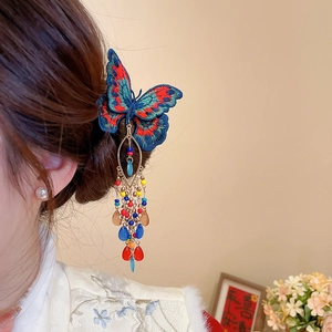 Detailed close-up of butterfly embroidery hair clip with colorful crystal tassel fringe
