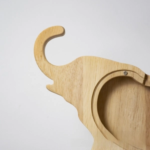 Close-up of elephant wooden piggy bank showing natural wood grain and acrylic panel