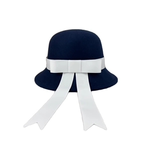 Elegant navy blue wool felt bucket hat with a large white ribbon bow and streamers