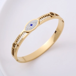 Gold hollow gear-edged bracelet with inlaid blue diamond evil eye charm for women