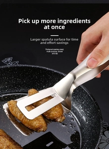Macro shot of a stainless steel multipurpose spatula clip flipping a steak in a pan
