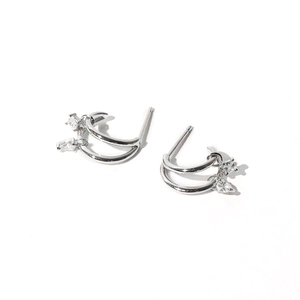 Detail view of double layer silver earrings with sparkling zircon stones on white background