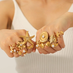 Vintage starfish shell ring set with pearls in gold finish on female model hands