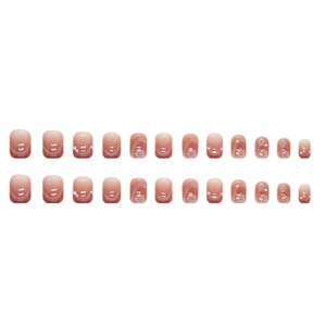 Pink gradient press-on nails with white floral patterns, lines and small pearls