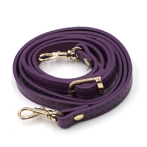Macro view of purple PU leather strap featuring golden metal hooks and adjustable buckle