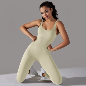 Detailed macro view of the ribbed knit fabric and seamless stitching on a yellow yoga bodysuit