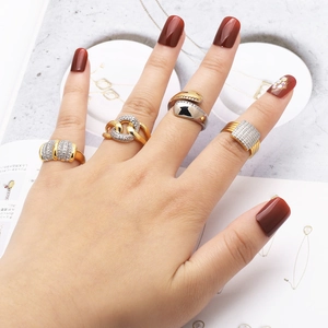 Modern gold and silver rings with zircon stones shown in a stacked style for women