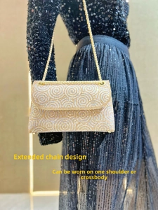 Detail of elegant gold rhinestone evening bag with extended chain for shoulder or crossbody