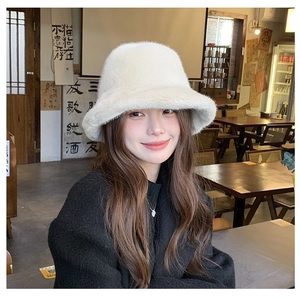 Detailed close-up showing the soft plush texture of the cream winter bucket hat