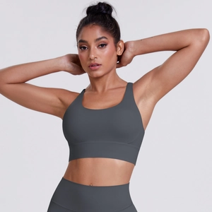 Detail of high-waist yoga pants and criss-cross back sports bra in charcoal grey fabric