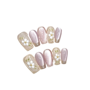 Pink cat eye press-on nails with floral hand-painted designs and gold French tips
