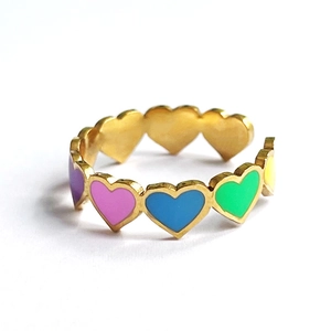 Detail of gold-plated open ring featuring multi-colored enamel hearts in rainbow style
