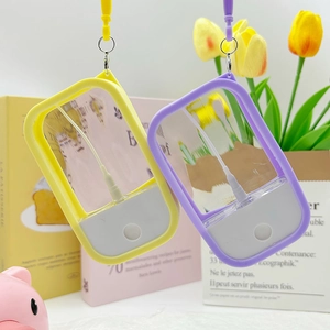 Portable macaron spray bottles in yellow and purple with silicone lanyards for travel