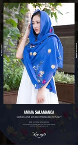 Macro detail of royal blue cotton linen scarf with colorful floral embroidery patterns