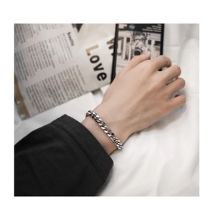 Sleek silver stainless steel Cuban link bracelet for men on wrist with trendy vibe