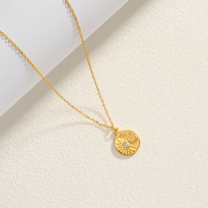 Detail of 18K gold-plated star and moon pendant with shimmering cubic zirconia stone