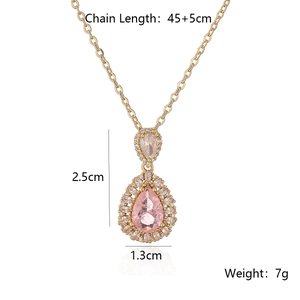 Detail view of 18K gold plated necklace with pink pear-cut zircon and white crystal accents