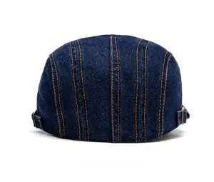 Rear view of denim newsboy cap featuring orange stitching and adjustable metal buckle
