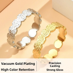 Close-up of adjustable stainless steel rings with embossed vintage floral wave textures