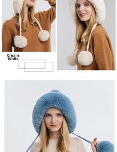 Detail of warm winter knit hat with soft pom-poms and fleece lining in cream white and blue
