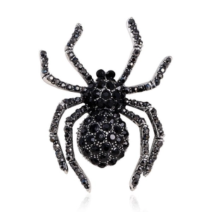 Retro spider brooch with black crystals on silver metal base, professional studio shot