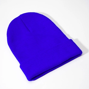 Detail of royal blue ribbed knit beanie with wide fold-over cuff for winter